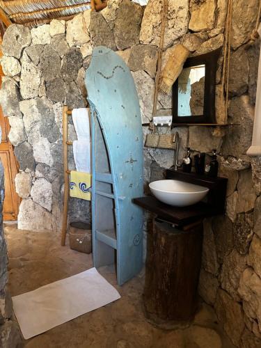 a bathroom with a blue door next to a sink at Manga Bay Lodge in Toliara