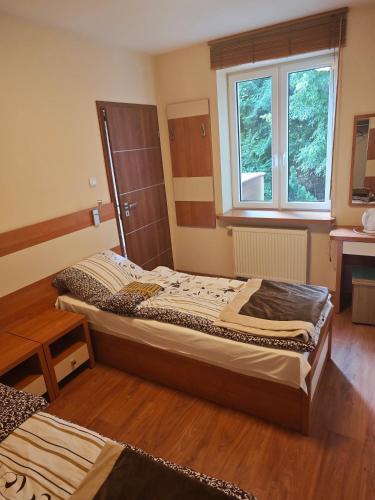 a bedroom with two beds and a window at OW Viva in Jantar