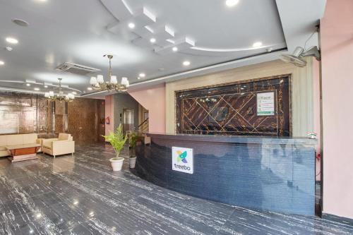 a large room with a lobby with a large window at Treebo Prem Tower in Haldwāni