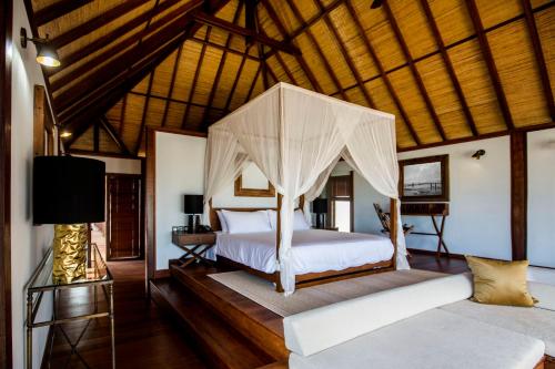 a bedroom with a bed with a canopy at Sentidos Beach Retreat in Miramar