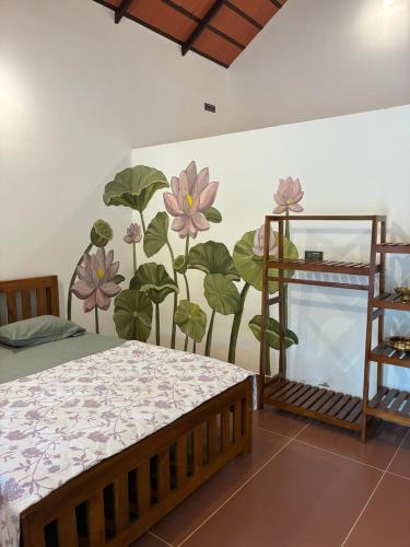 a bedroom with a flower mural on the wall at Fiddlehead Fern in Kurchi