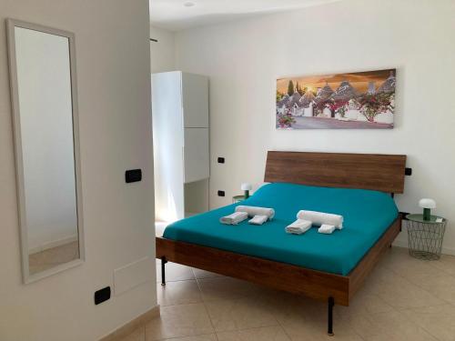 a bedroom with a bed with two towels on it at Suite 93 in Mola di Bari
