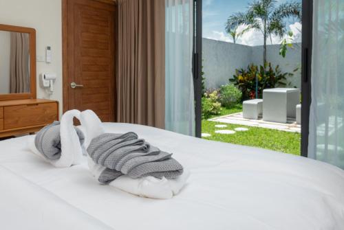 a hotel room with a bed with towels on it at Turtle Tales-Tao Khon in Thai Muang