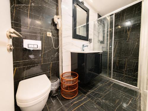 łazienka z toaletą, umywalką i prysznicem w obiekcie Kavi Hotel w Stambule