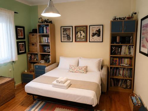 a bedroom with a bed and bookshelves at The Secret Garden Peraia in Perea