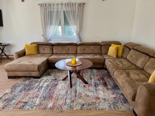 a living room with a couch and a table at SAN Apartments Near Belgrade Airport in Surčin