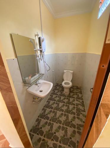 a bathroom with a sink and a toilet at Senmonorom in Senmonorom