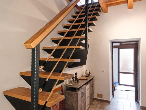 a wooden staircase in a room with a stair case at Casa Ada con Terraza Panorámica al Roque Bentayga by Canarias Prime Homes in Tejeda