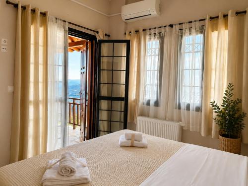 a bedroom with a bed with two towels on it at Stagiates House in Stagiates