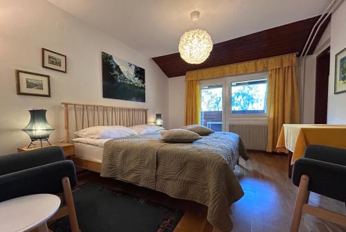 a bedroom with two beds and a window at Hiša ob jezeru - House by the Lake in Kranjska Gora
