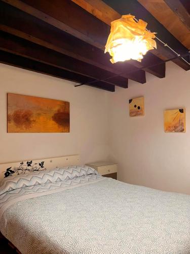 a bedroom with a white bed and paintings on the wall at Loft Boutique con Encanto in Montilla