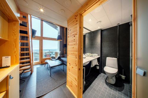 a bathroom with a sink and a toilet in a room at Star Arctic Hotel & Activities in Saariselka
