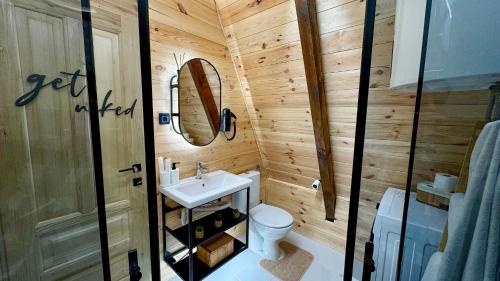 a small bathroom with a toilet and a sink at Horizons by PeaksView Chalets in Žabljak