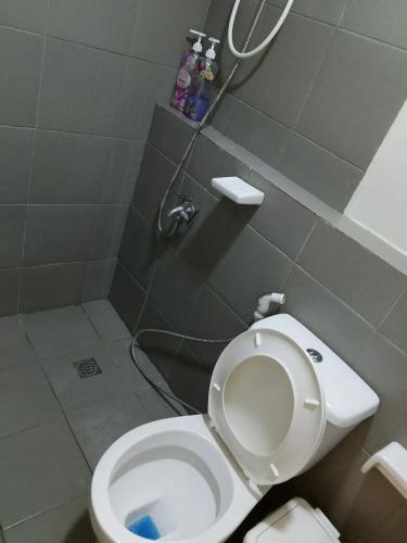 a bathroom with a white toilet and a shower at spacious condo unit 1P olvera residences in Bacolod