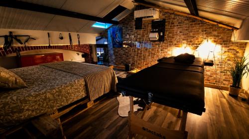 a bedroom with a bed and a brick wall at Maison LOVEROOM 70m2 L'entre Nous in Grenoble