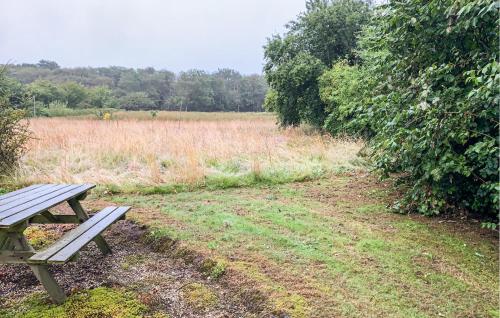 a picnic table sitting in front of a field at 2 Bedroom Nice Home In Nørre Nebel in Nørre Nebel