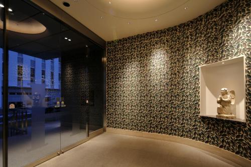 a room with a wall with a patterned wall at Hotel Monte Hermana Fukuoka in Fukuoka