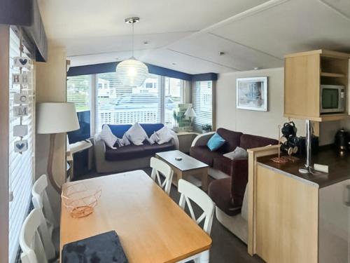a living room with a couch and a table at 86 Cader Idris in Pwllheli