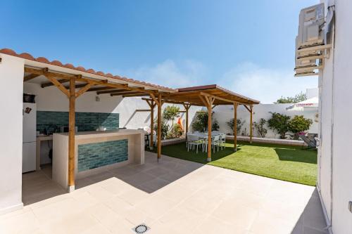a backyard with a kitchen and a pergola at MalagaSuite Villa Flor de Piedra in Fuente de Piedra