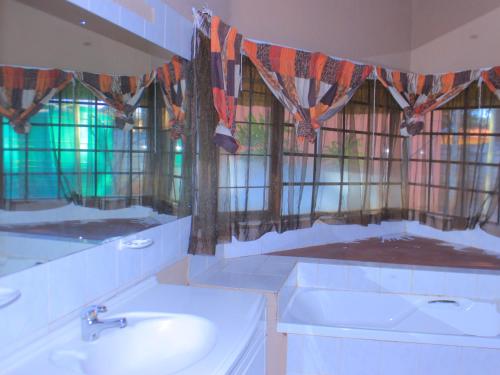 a bathroom with a sink and stained glass windows at Kat Guest house in Northam