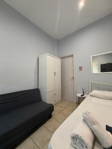 a bedroom with a bed and a white cabinet at Athanias Studio in Drama