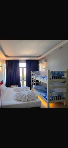 a bedroom with two bunk beds and a window at Flogeri in Vlorë