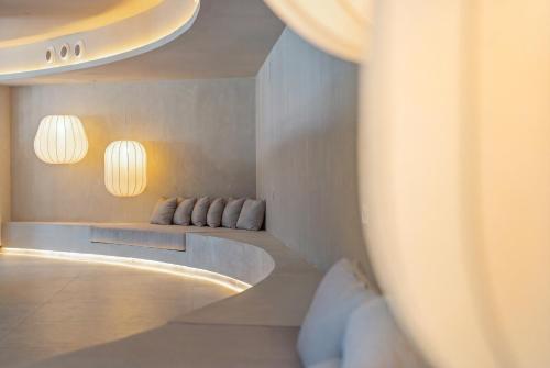 a room with two chairs and two lights on the wall at Gran Hotel Suances Suites in Suances