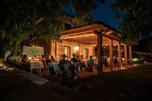 a group of people sitting at a restaurant at night at Fons Clara Domus et Eventi in Fontechiari