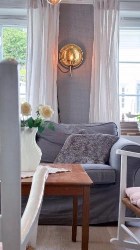 a living room with a couch and a table at Charming and historic house in Flekkefjord