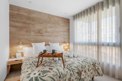 a bedroom with a bed with a table on it at Pinatar Luxury in San Pedro del Pinatar