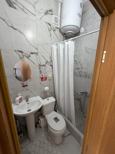 a bathroom with a toilet and a sink and a shower at Athanias Studio II in Drama
