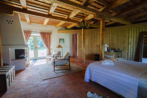 a bedroom with a bed and a living room at Polixenia Culinary Estate 