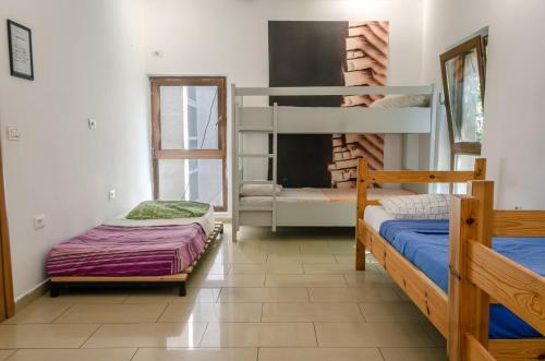 a room with two bunk beds and a couch at Buff Hostel Tirana in Tirana