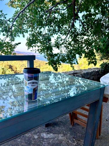a blue bench with a cup on top of it at Avgonima Sunset Medvial Suite in Chios