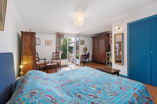 a bedroom with a bed and a living room at Chambre D'hôtes Le Viel Echalier in Saint-Urbain