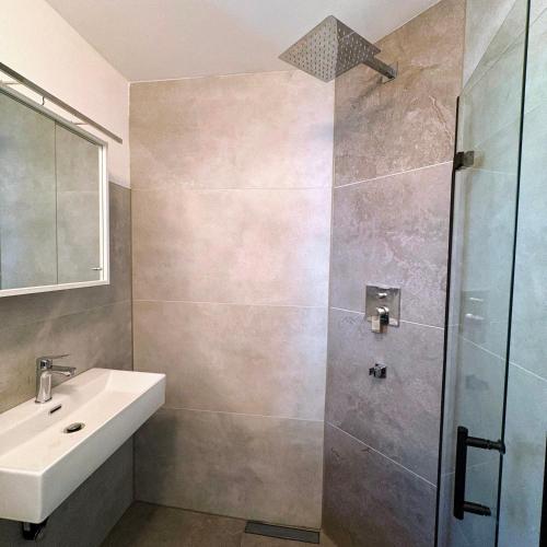 a bathroom with a sink and a shower at TourBase Dahlem in Dahlem