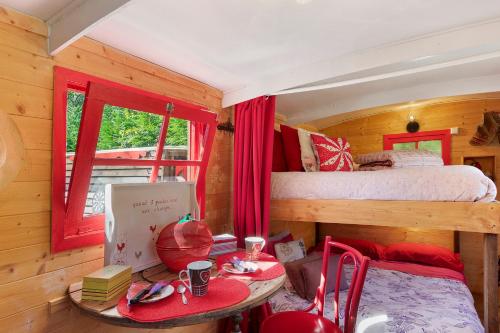 a room with a bed and a table in a room at Roulotte Champêtre Bella in Brix