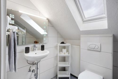 a bathroom with a sink and a skylight at Schwarzwaldglück 2 Einheiten in St. Blasien