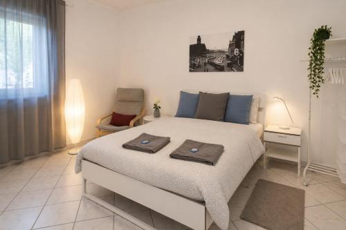 a bedroom with a bed with two towels on it at Kirchberg Comfort Rooms in Luxembourg