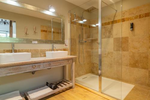 a bathroom with two sinks and a shower at L'ormeau in Charols