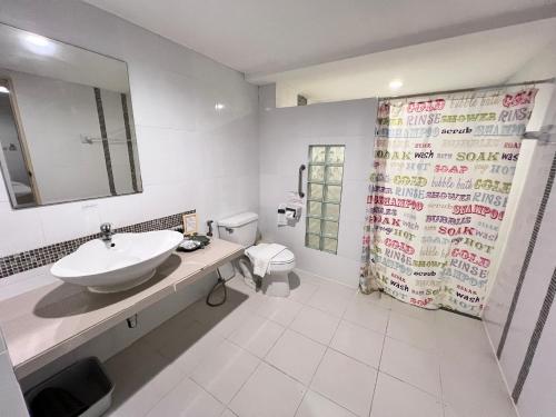 a bathroom with a sink and a toilet and a shower at The Terrace Hotel in Nakhon Si Thammarat