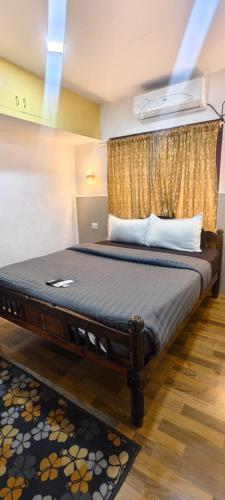 a bedroom with a large bed with a window at COCHIN CINEMA Rooms in Cochin