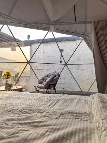 a bedroom with a bed in a tent at شاليهات سكوْن in Al Baha