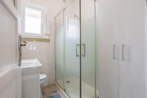 a bathroom with a glass shower and a toilet at AL Fancy Discoveries in Lisbon