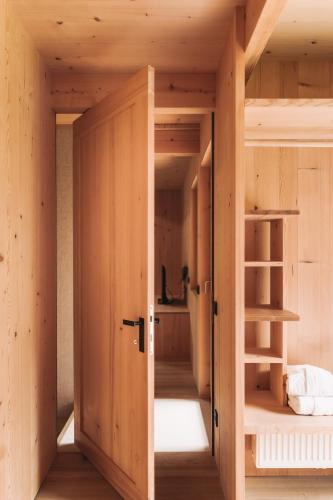 a room with a bunk bed and a open door at Ferienhaus Islen in Mellau