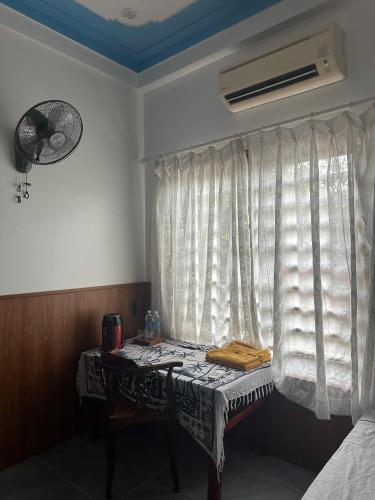 a room with a table in front of a window at Highway 20 Homestay in Phong Nha