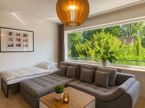 a living room with a couch and a large window at Moscow Areal Suite in Baden-Baden