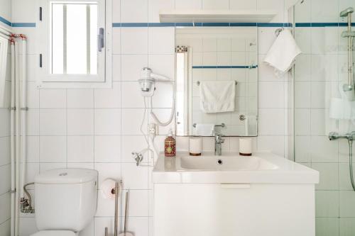 a white bathroom with a toilet and a sink at Vittorio Fabulous View in Tías