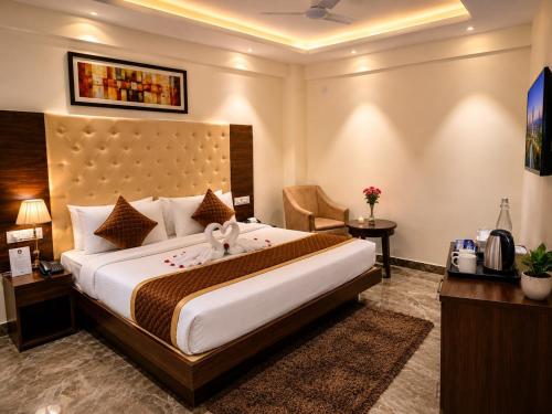 a bedroom with a large bed in a hotel room at IndiGo Line Hotel - Opp Paradise Biryani Shamshabad in Hyderabad