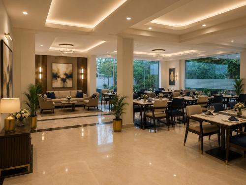 a restaurant with tables and chairs in a room at IndiGo Line Hotel - Opp Paradise Biryani Shamshabad in Hyderabad